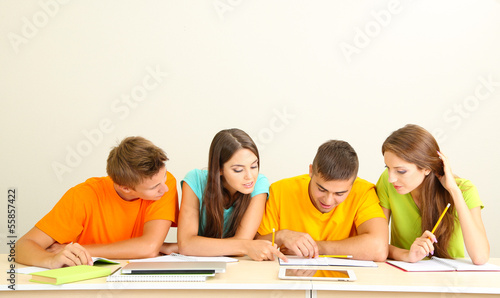 Photo: Group of young students sitting in the room Group of young students sitting in the room