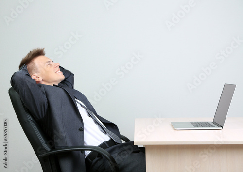 Photo: Portrait of young businessman in office Portrait of young businessman in office
