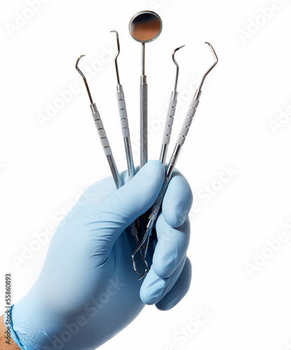 Photo: Hand with professional dental tools. Hand with professional dental tools.