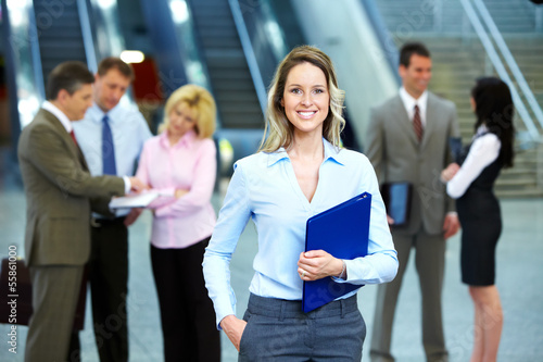 Photo: Business woman and a group of workers. Business woman and a group of workers.
