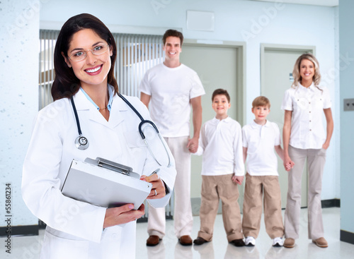Photo: Smiling medical doctor woman and family. Smiling medical doctor woman and family.