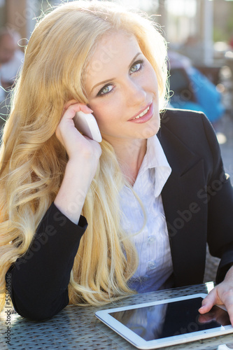 Photo: woman using mobile phone and digital tablet woman using mobile phone and digital tablet