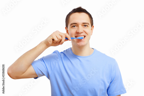Photo: Young man at home brushing teeth Young man at home brushing teeth