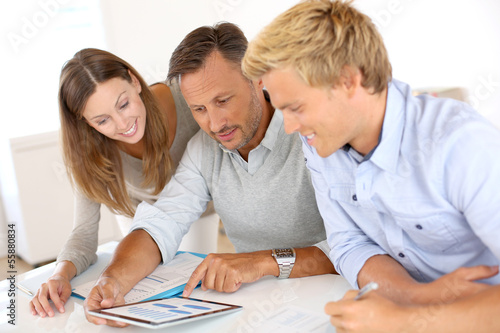 Photo: Marketing people working on business plan Marketing people working on business plan