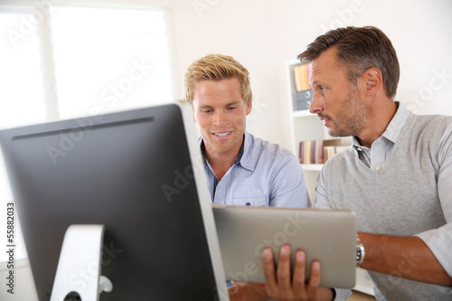 Photo: Manager with employee working in office Manager with employee working in office