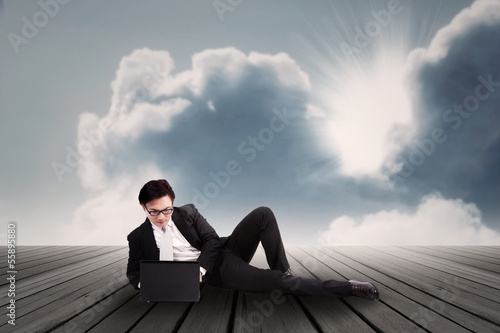 Photo: Businessman working on laptop outdoor Businessman working on laptop outdoor