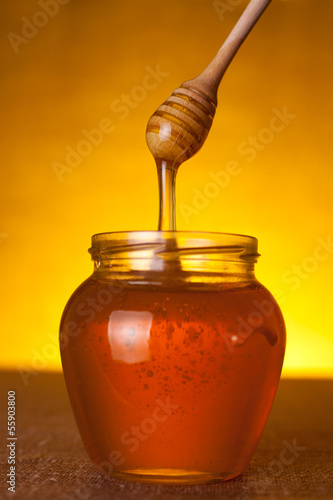 Photo: Honey jar with wooden dipper Honey jar with wooden dipper