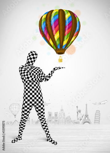 Photo: man in full body suit holding balloon man in full body suit holding balloon