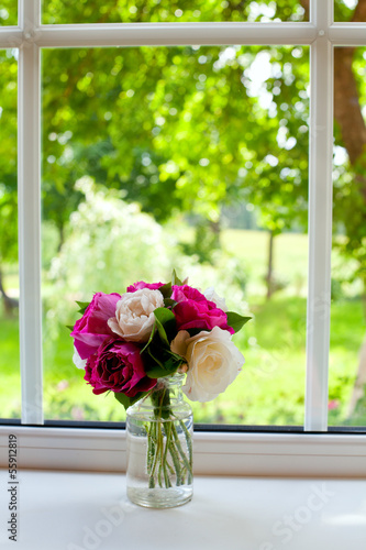 Photo: white and violet roses on window sill white and violet roses on window sill