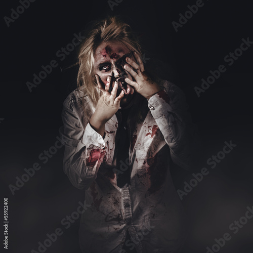 Photo: Dark halloween portrait. Scary evil zombie Dark halloween portrait. Scary evil zombie