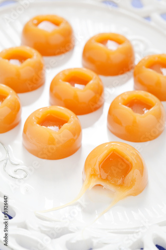 Photo: Homemade salted caramel candy on white plate, selective focus Homemade salted caramel candy on white plate, selective focus