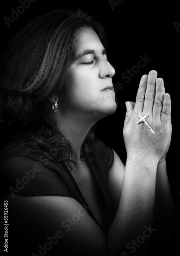 Photo: Black and white portrait of an hispanic woman praying Black and white portrait of an hispanic woman praying