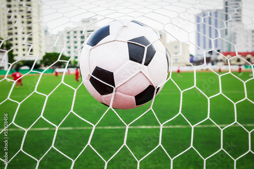 Photo: soccer ball in goal net soccer ball in goal net