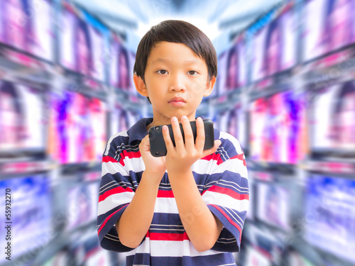 Photo: young boy using mobile phone young boy using mobile phone