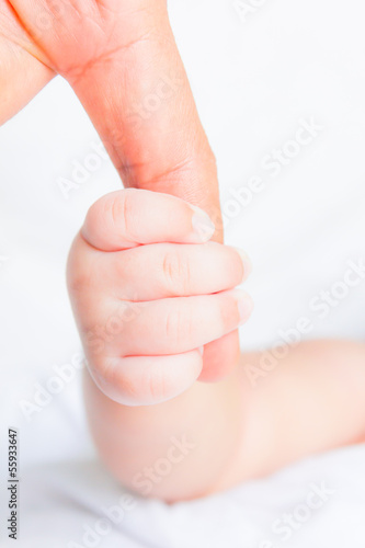 Photo: baby hand holding adult finger baby hand holding adult finger