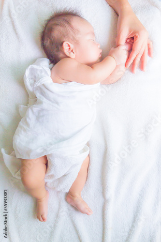 Photo: sleeping baby holding mom hand sleeping baby holding mom hand