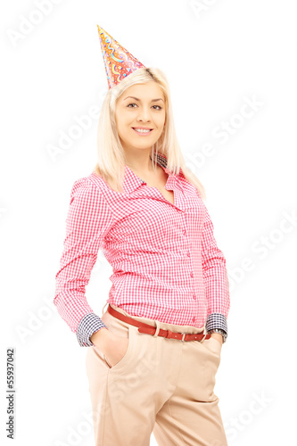 Photo: Smiling birthday female with a party hat posing Smiling birthday female with a party hat posing