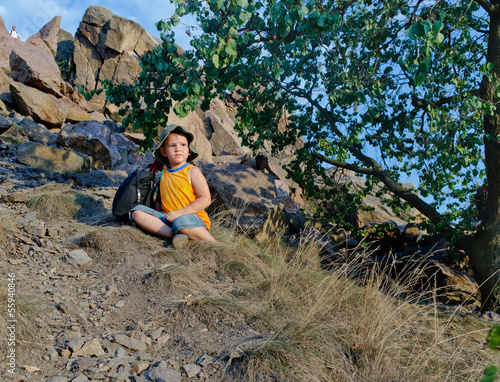Photo: Little boy waiting patiently on a mountain slope Little boy waiting patiently on a mountain slope