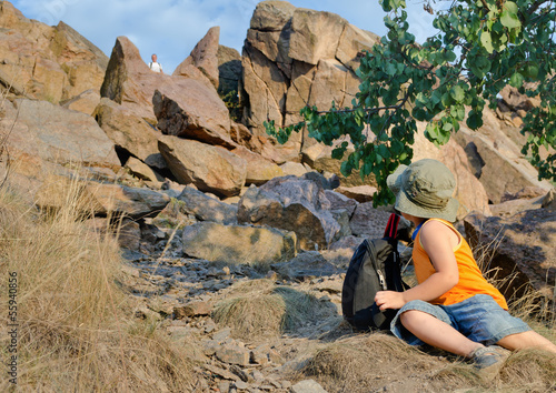 Photo: Little boy on a mountainside looking back Little boy on a mountainside looking back