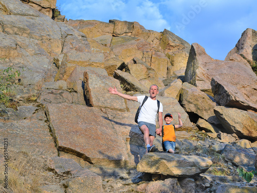 Photo: Happy father holding the hand of his little boy Happy father holding the hand of his little boy