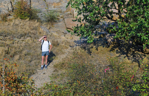 Photo: Man out backpacking on a mountain path Man out backpacking on a mountain path