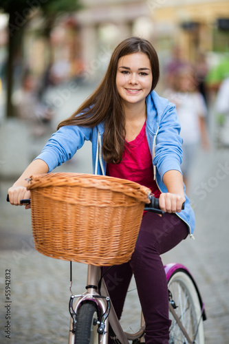 Photo: Urban biking - teenage girl and bike in city Urban biking - teenage girl and bike in city