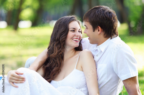 Photo: Young love Couple smiling under blue sky Young love Couple smiling under blue sky