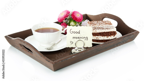 Photo: Cup of tea with cakes on wooden tray isolated on white Cup of tea with cakes on wooden tray isolated on white
