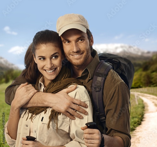 Photo: Hiking couple embracing in countryside Hiking couple embracing in countryside