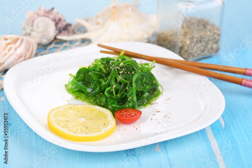Photo: Sea kale on plate on wooden table close-up Sea kale on plate on wooden table close-up