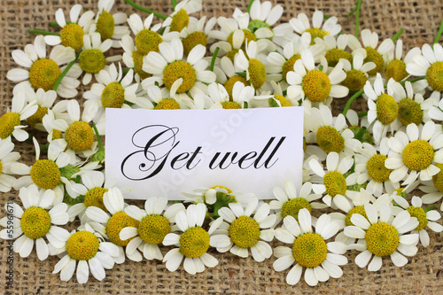 Photo: Get well card with chamomile flowers on jute surface Get well card with chamomile flowers on jute surface