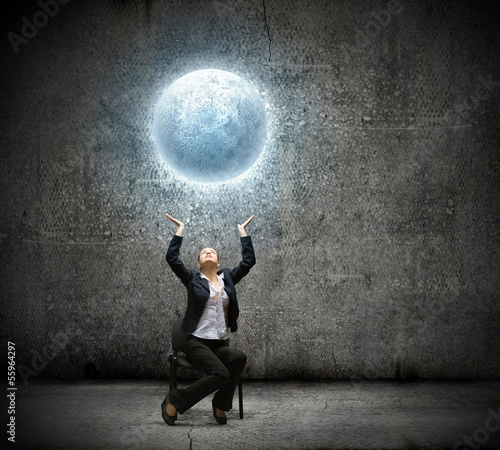 Photo: Businesswoman holding moon Businesswoman holding moon