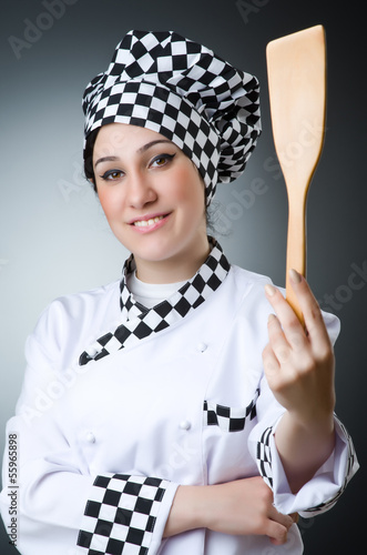 Photo: Pretty cook with kitchen utensils Pretty cook with kitchen utensils