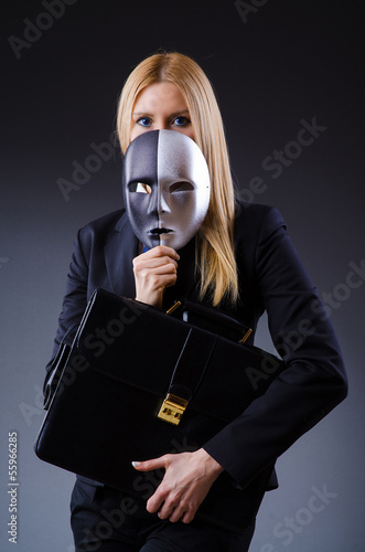 Photo: Woman with mask in hypocrisy concept Woman with mask in hypocrisy concept