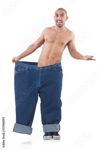 Photo: Man in dieting concept with oversized jeans Man in dieting concept with oversized jeans