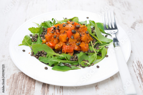 Photo: plate of salad with arugula, black lentils and vegetable stew plate of salad with arugula, black lentils and vegetable stew
