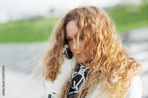 Photo: Beautiful woman calling on the phone Beautiful woman calling on the phone