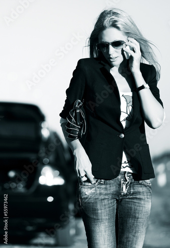 Photo: Young woman in sunglasses calling on the phone Young woman in sunglasses calling on the phone