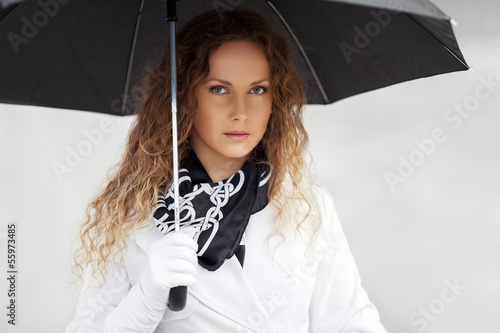 Photo: Sad beautiful woman with umbrella Sad beautiful woman with umbrella