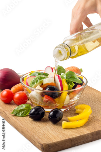 Photo: Preparing greek salad with olive oil Preparing greek salad with olive oil