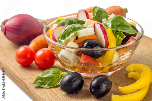 Photo: Salad with vegetables around isolated on white background Salad with vegetables around isolated on white background