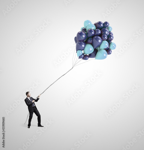 Photo: man holding balloons man holding balloons