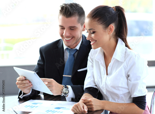 Photo: Business people meeting in office to discuss project Business people meeting in office to discuss project