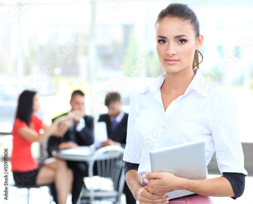 Photo: Face of beautiful woman on the background of business people Face of beautiful woman on the background of business people