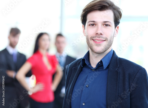 Photo: Happy smart business man with team mates discussing Happy smart business man with team mates discussing