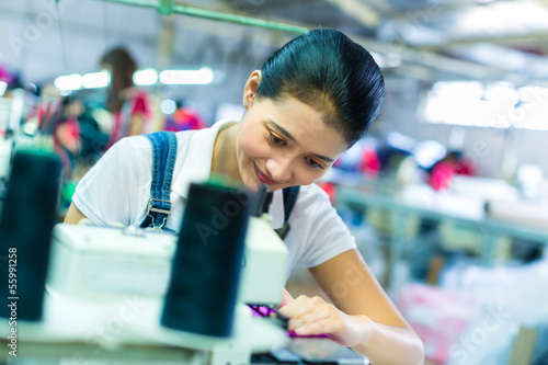 Photo: Indonesian seamstress in a textile factory Indonesian seamstress in a textile factory