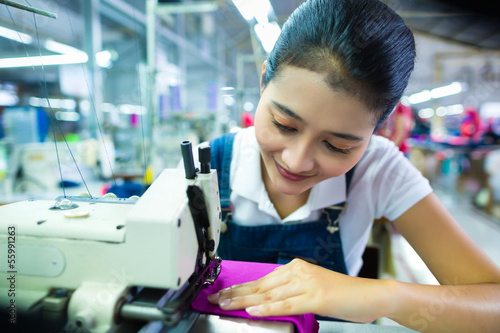 Photo: Indonesian seamstress in a textile factory Indonesian seamstress in a textile factory