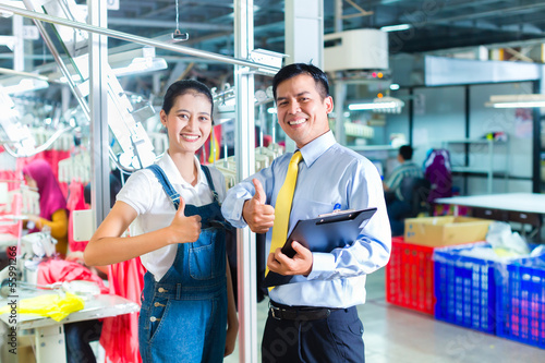Photo: Asian foreman in textile factory giving training Asian foreman in textile factory giving training