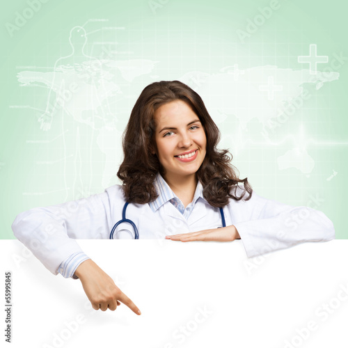 Photo: young woman doctor with a blank banner young woman doctor with a blank banner