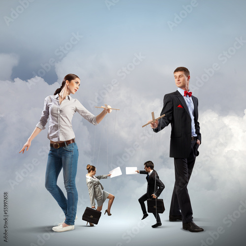 Photo: Businesspeople with marionettes Businesspeople with marionettes